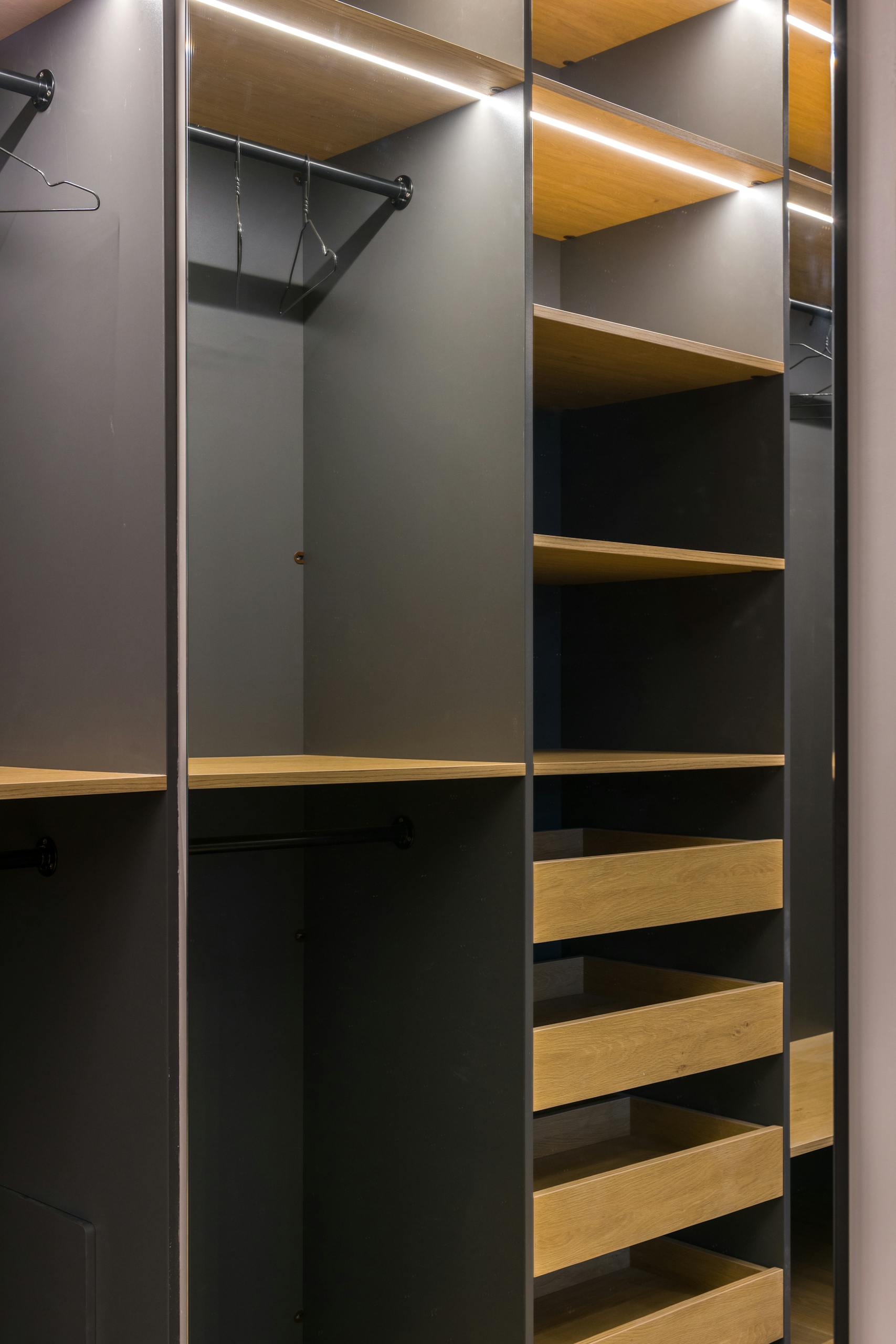 Minimalist modern wardrobe with empty shelves and hangers, perfect for organization.